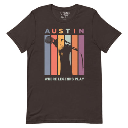 A brown t-shirt featuring a silhouette of a hand holding a microphone with the words "Austin. Where legends play".
