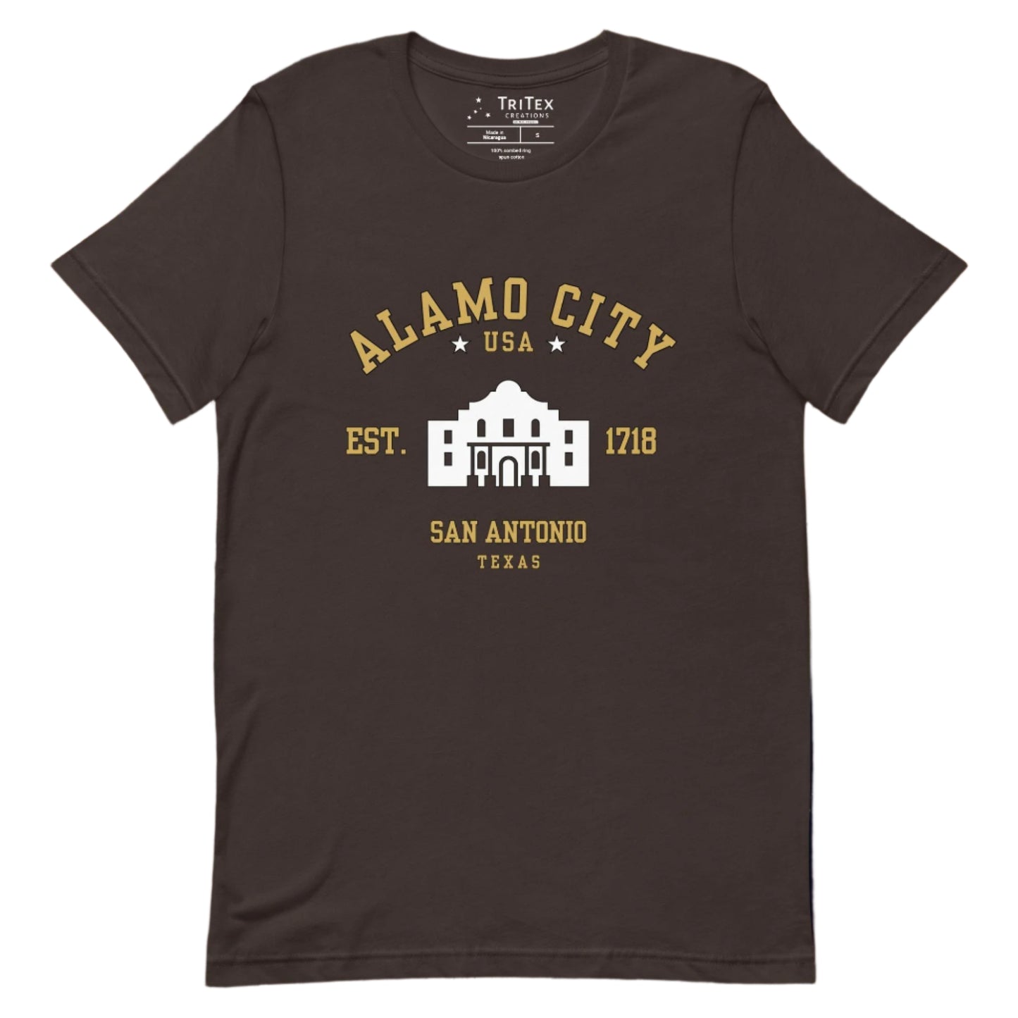 A brown t-shirt featuring an image of The Alamo with the words "Alamo City USA Est. 1718 San Antonio Texas".