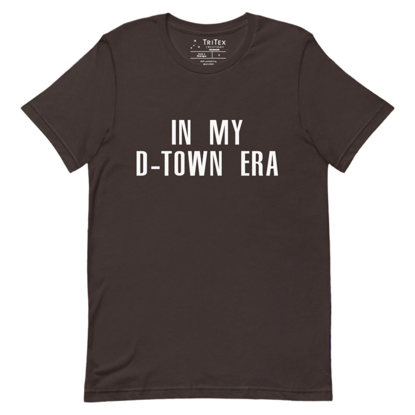 A brown t-shirt with the text "In my d-town era.