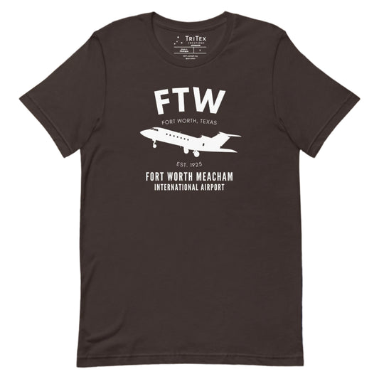 A brown t-shirt featuring a small passenger jet with the words "FTW Fort Worth, Texas Est. 1925. Fort Worth Meacham International Airport".