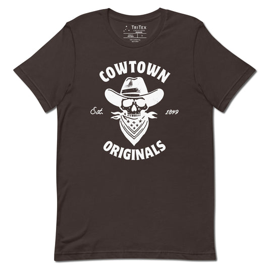 A brown t-shirt with an image of a  skull in a cowboy hat and kerchief which reads "Cowtown Originals Est. 1849".