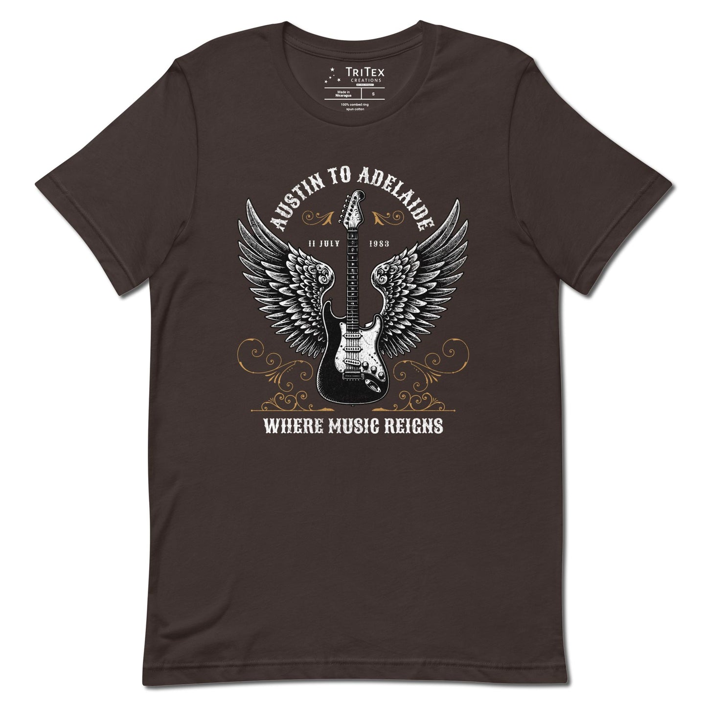 A brown t-shirt featuring an electric guitar with wings and the words "Austin to Adelaide 11 July 1983. Where music reigns".