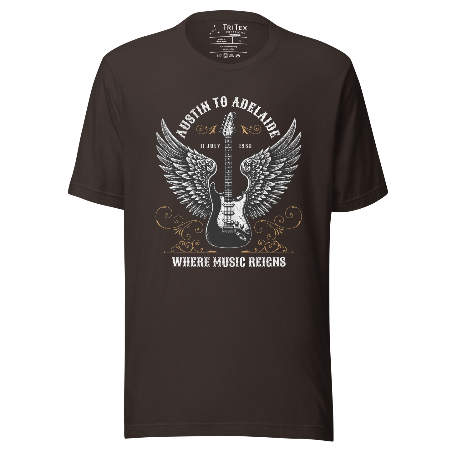 A vintage brown t-shirt featuring an electric guitar with wings and the words "Austin to Adelaide 11 July 1983. Where music reigns".