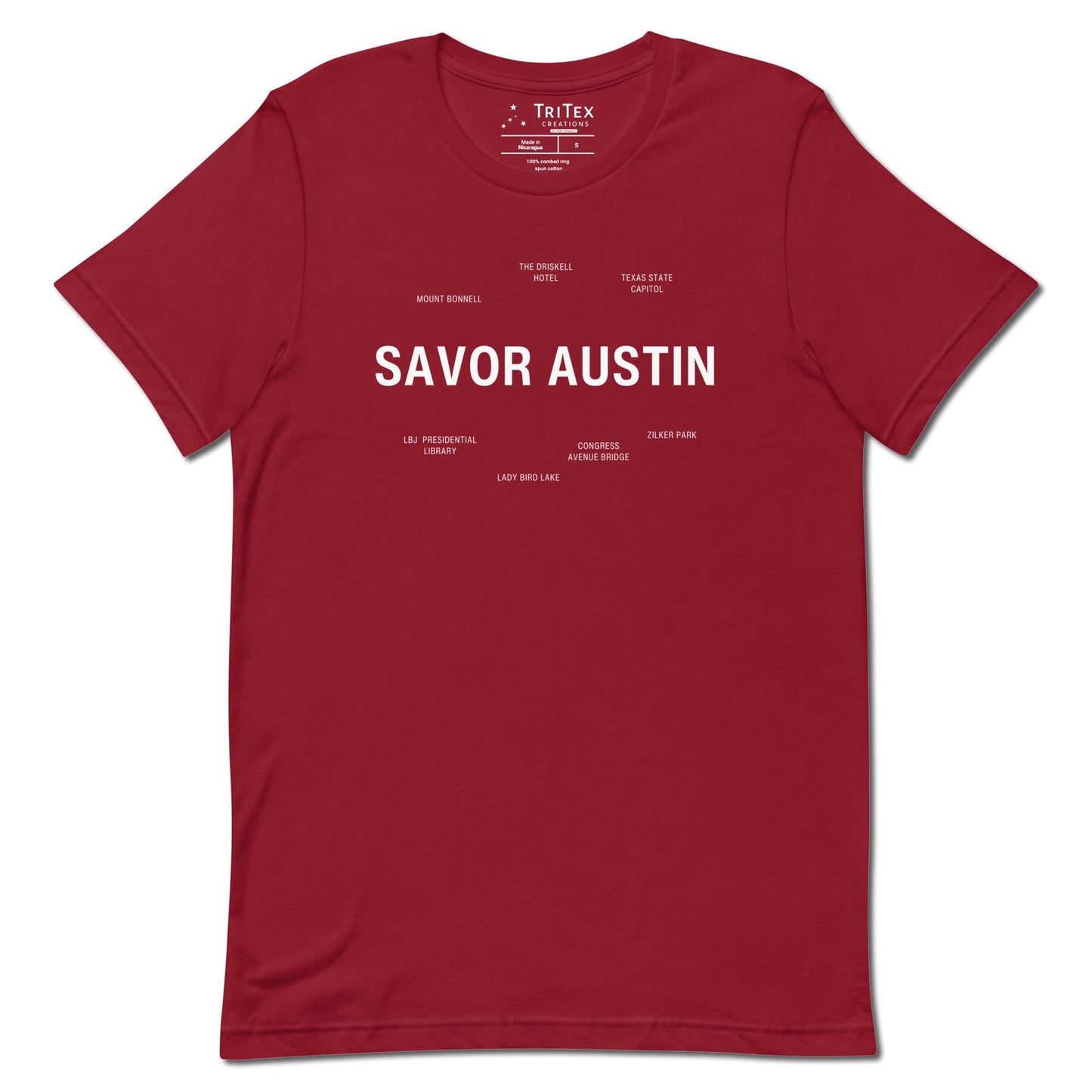 A cardinal red t-shirt which reads "Savor Austin" in big, bold text with smaller text elements naming Austin's landmarks.