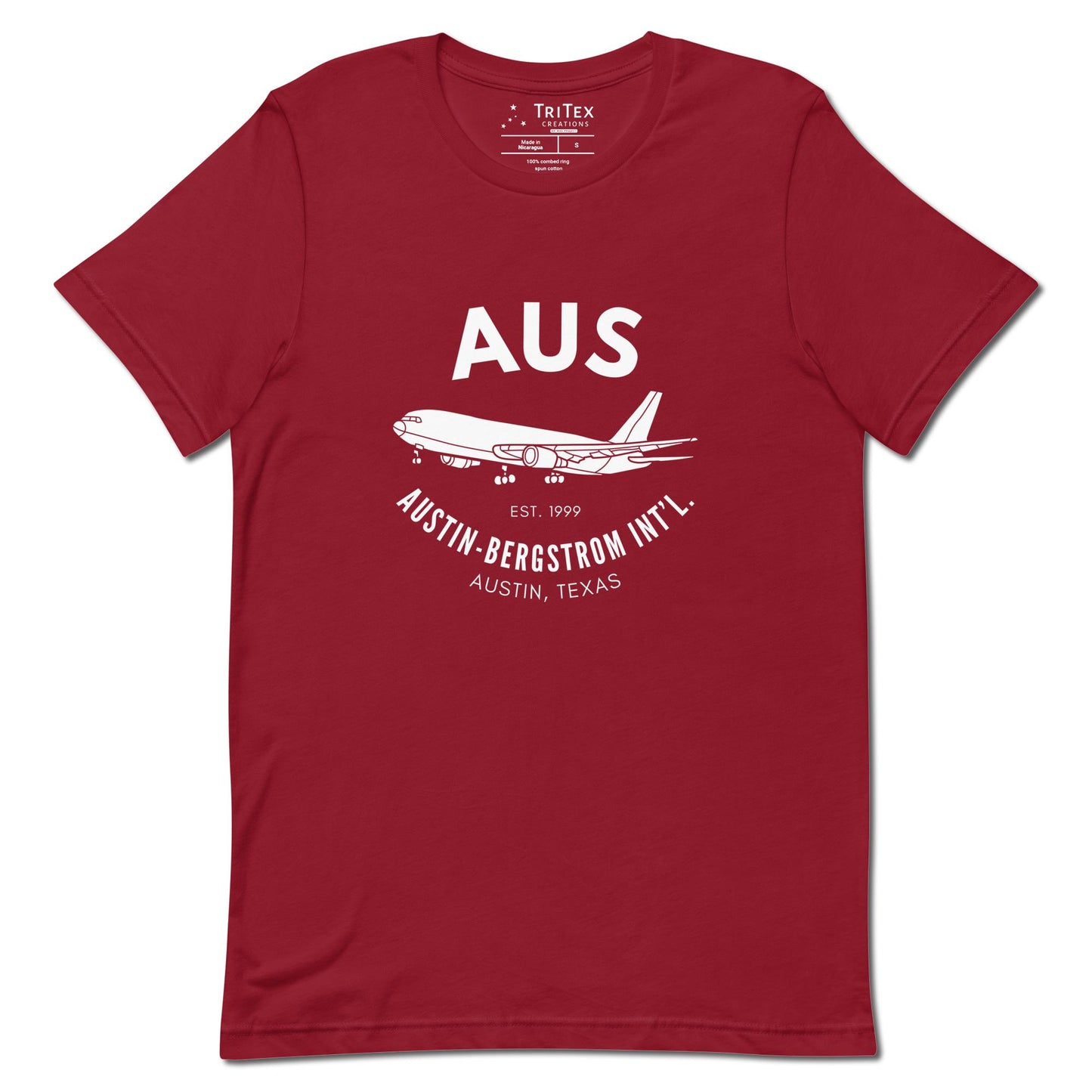 A cardinal red shirt featuring an image of an airplane with the words "AUS Est. 1999 Austin-Bergstrom Int'l. Austin, Texas".