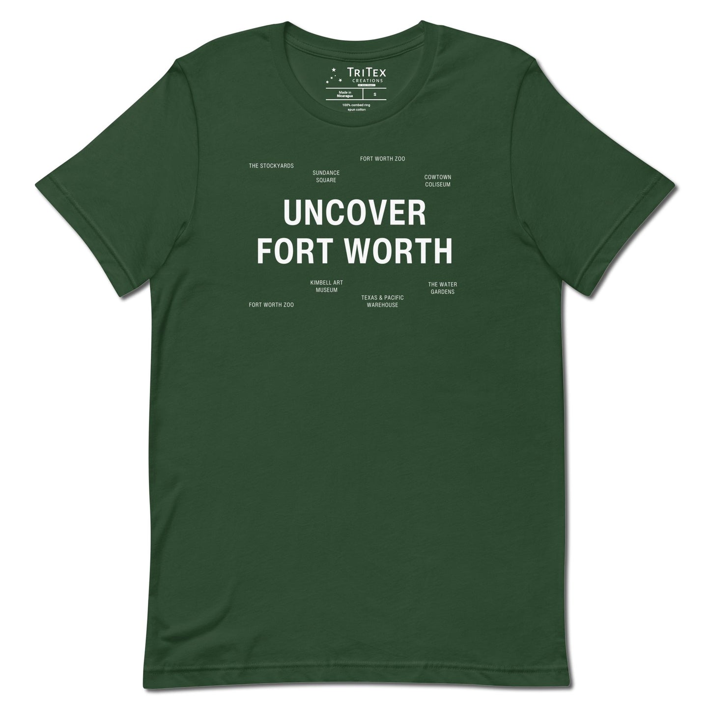 A forest green t-shirt which reads "Uncover Fort Worth" in big, bold text with smaller text elements naming Fort Worth landmarks.