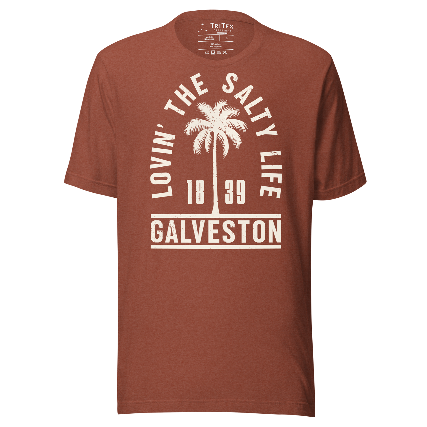 A heather clay t-shirt featuring the silhouette of a palm tree with the words "Lovin' the salty life. Galveston 1839".