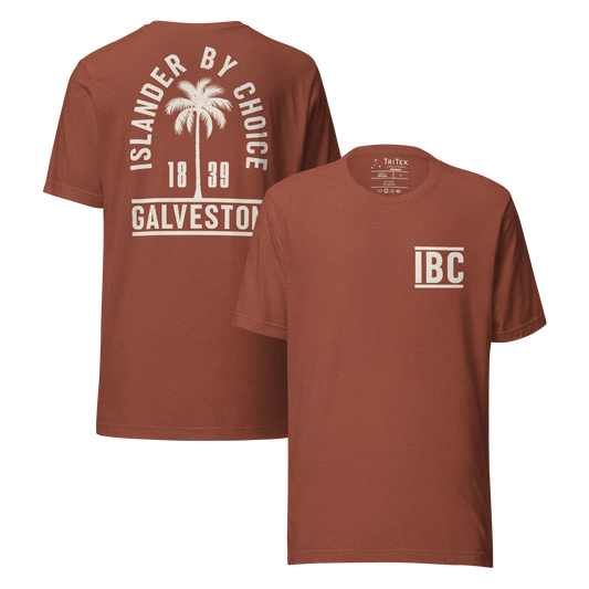 The front and back of a heather clay t-shirt. On the front: The letters "IBC". On the back: "Islander by choice. Galveston 1839" with a silhouette of a palm tree.