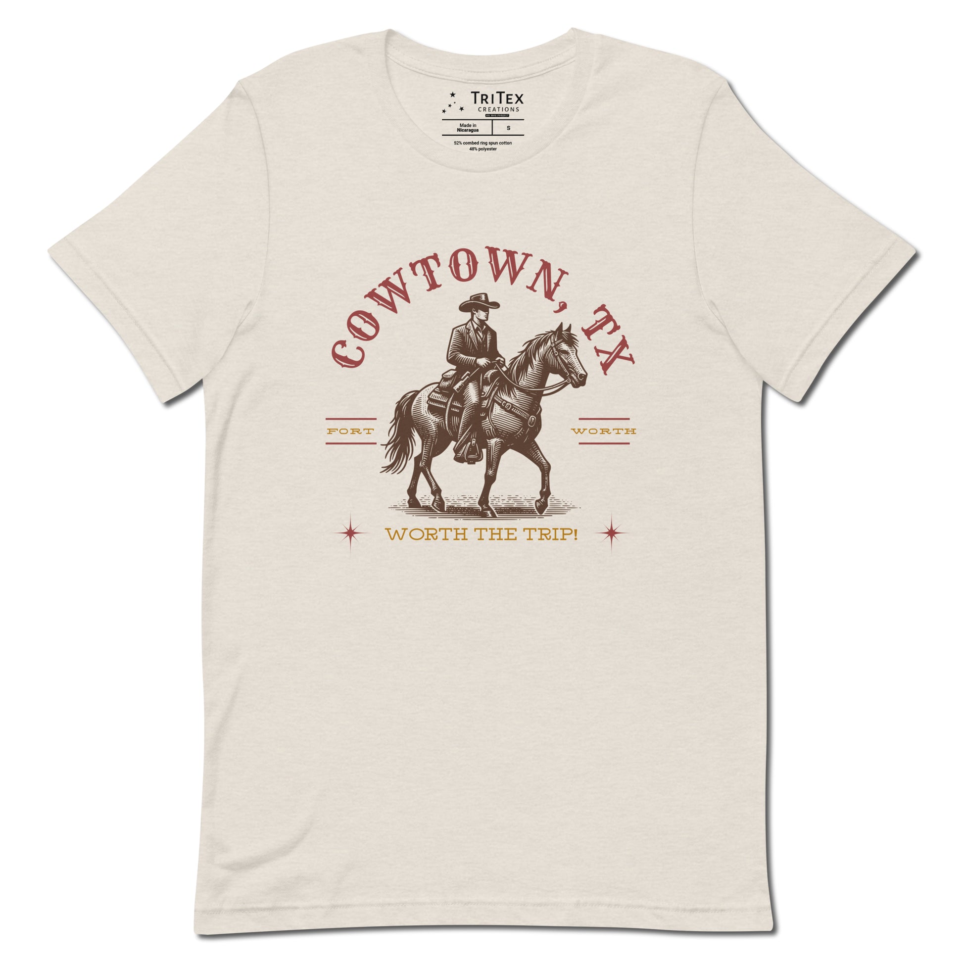 A heather dust t-shirt featuring a vintage illustration of a cowboy on a horse with the words "Cowtown, TX. Fort Worth. Worth the trip!"