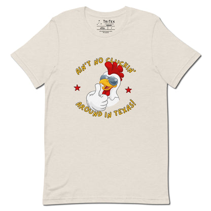 A heather dust t-shirt featuring an image of a chicken in sunglasses with the words "Ain't no cluckin' Texas". around in Texas!".