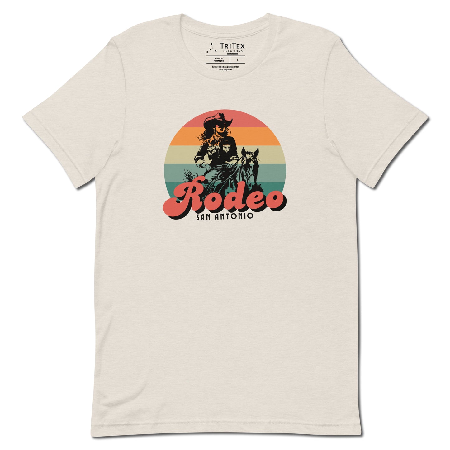 A heather dust t-shirt with an illustration of a cowgirl and the text "Rodeo San Antonio".