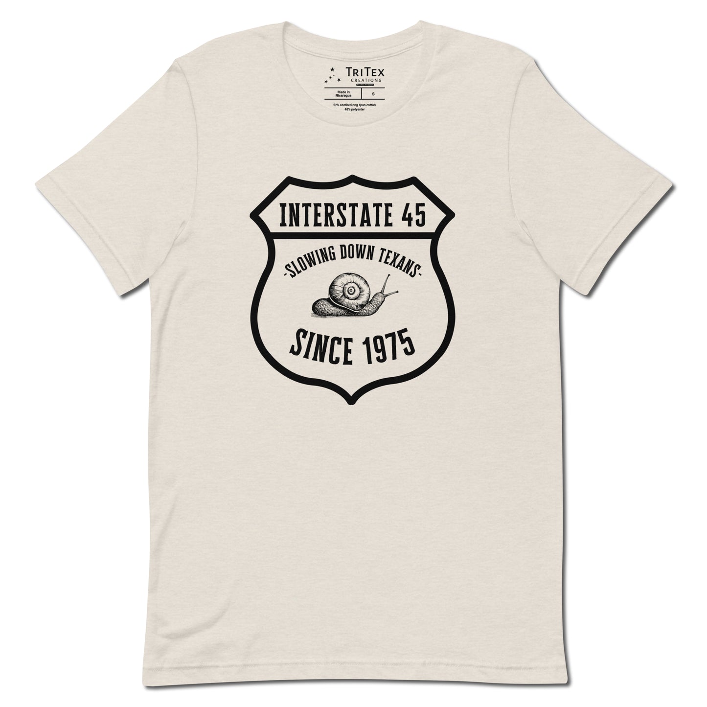 A heather dust t-shirt featuring a vintage illustration of a snail with the text "Interstate 45 slowing down Texans since 1975".