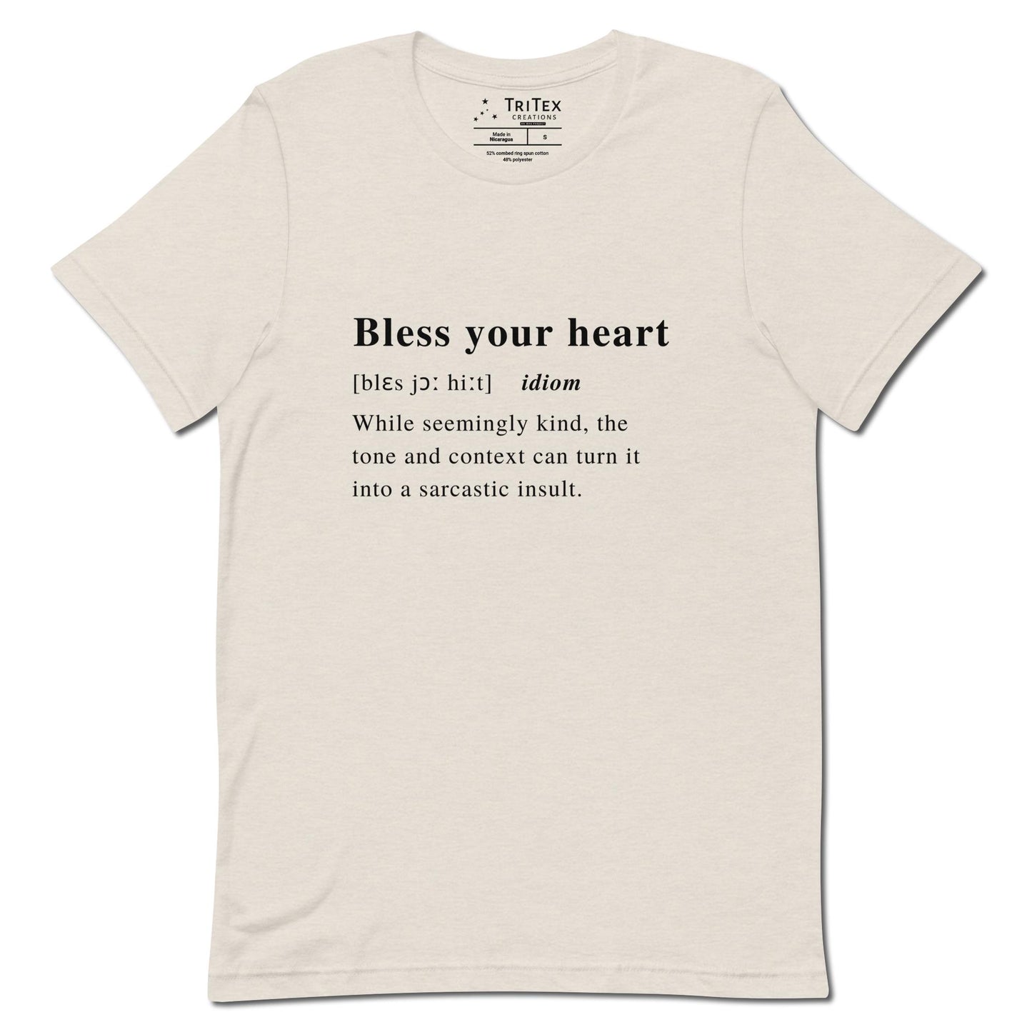 A heather dust t-shirt with the definition of "Bless your heart" styled like a dictionary entry