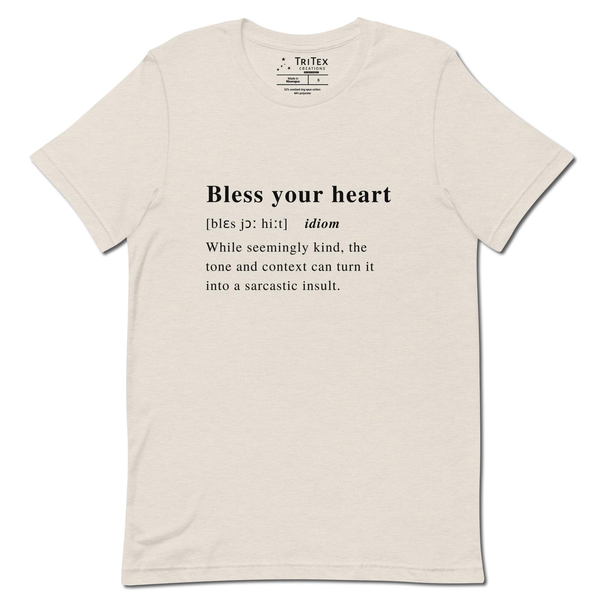 A heather dust t-shirt with the definition of "Bless your heart" styled like a dictionary entry