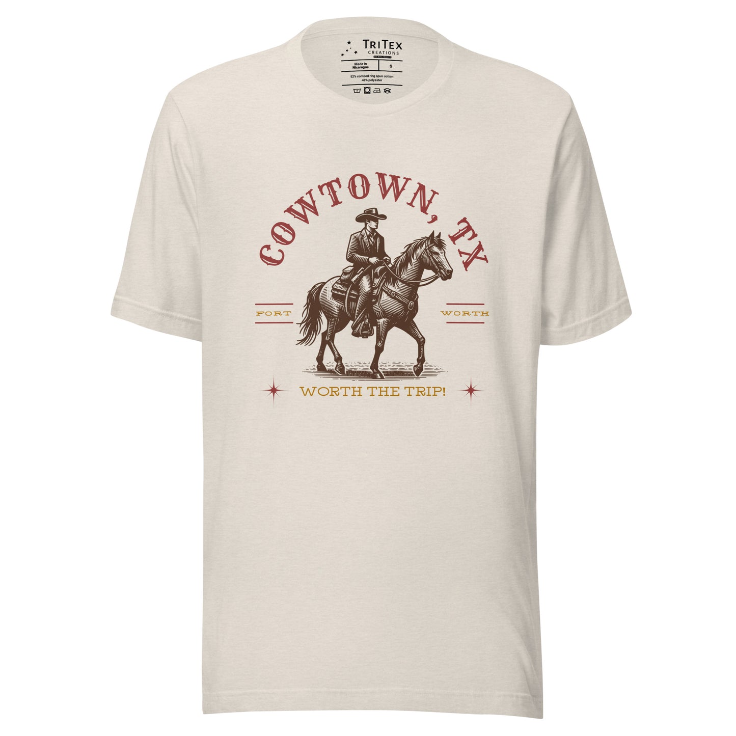 A heather dust t-shirt featuring a vintage illustration of a cowboy on a horse with the words "Cowtown, TX. Fort Worth. Worth the trip!"