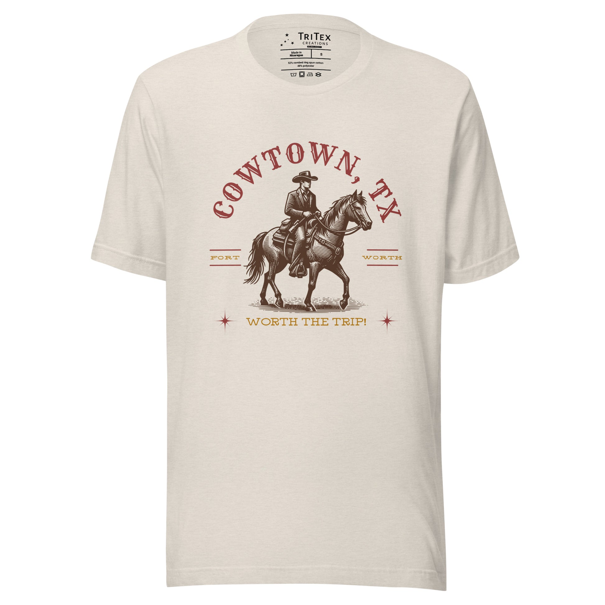 A heather dust t-shirt featuring a vintage illustration of a cowboy on a horse with the words "Cowtown, TX. Fort Worth. Worth the trip!"