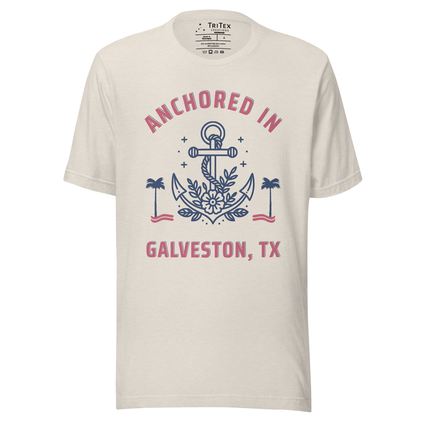 A heather dust t-shirt featuring an image of an anchor, palm trees and a flower with the text "Anchored in Galveston, TX".
