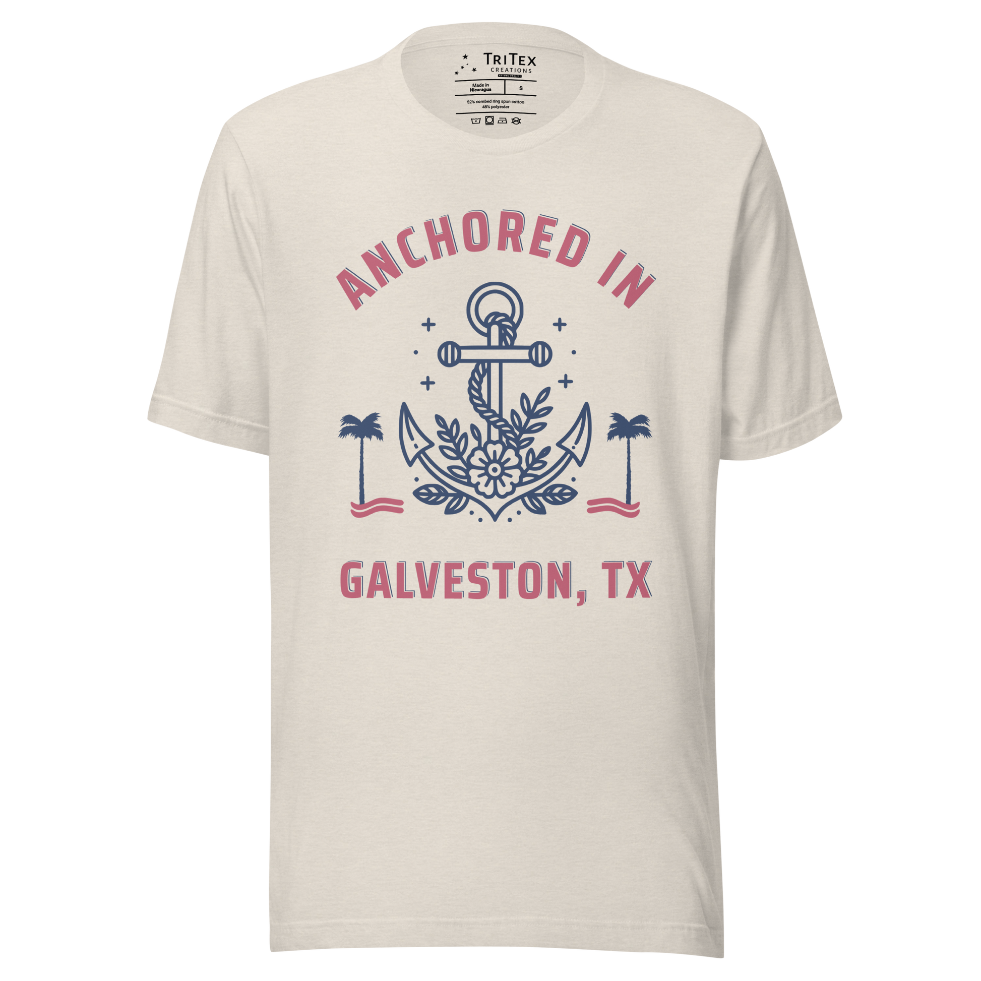 A heather dust t-shirt featuring an image of an anchor, palm trees and a flower with the text "Anchored in Galveston, TX".