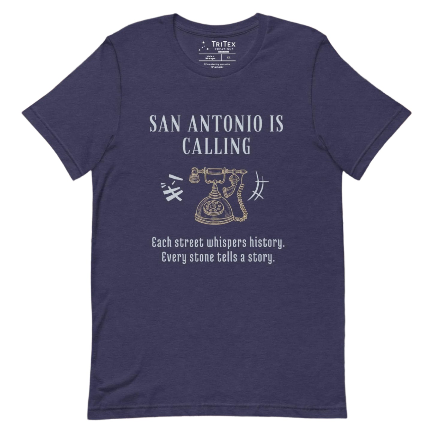 A heather midnight navy t-shirt featuring a graphic image of a vintage rotary phone with the text "San Antonio is calling. Each street whispers history. Every stone tells a story."