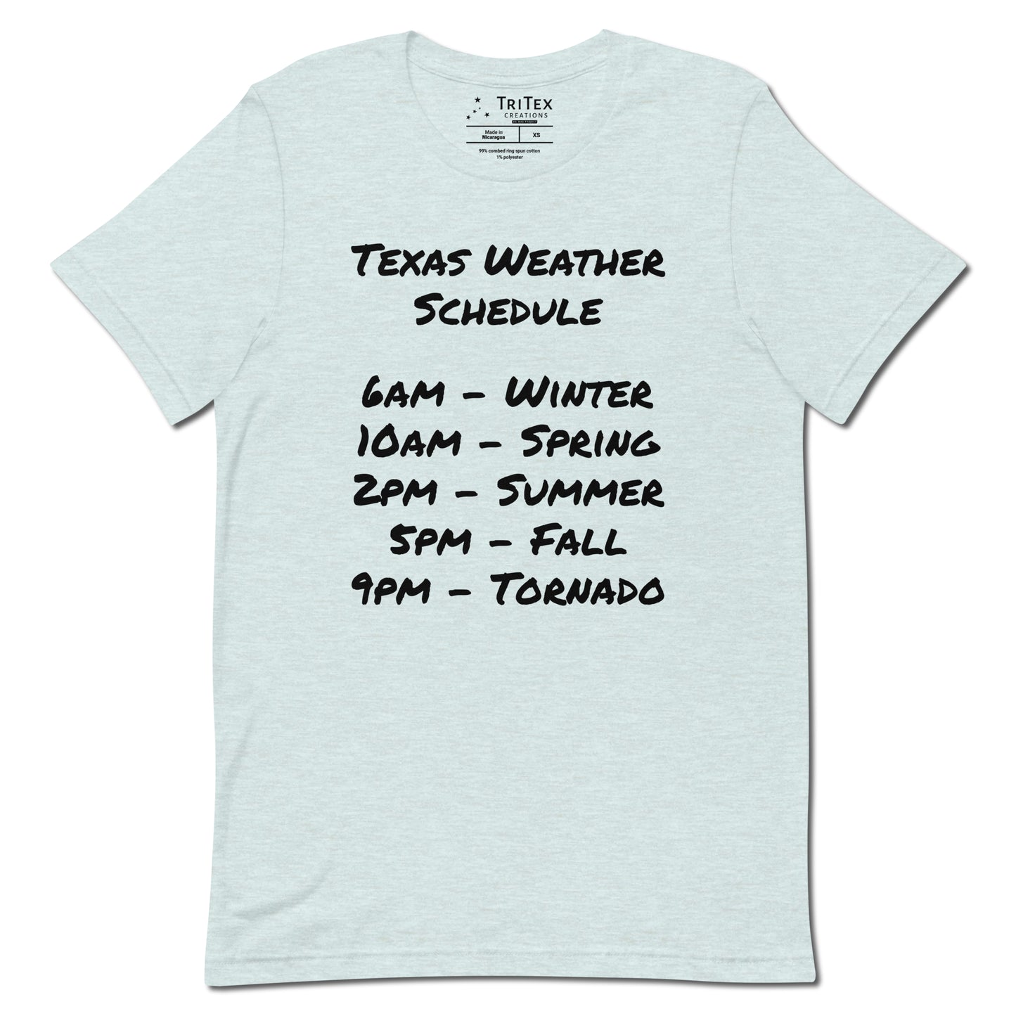 A heather prism ice blue t-shirt with a handwritten list that reads "Texas Weather Schedule. 6AM - Winter. 10AM - Spring. 2PM - Summer. 5PM - Fall. 9PM - Tornado".