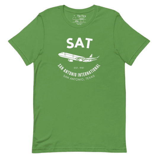 A leaf green t-shirt featuring a silhouette of a passenger plane with the text "SAT. Est. 1941. San Antonio International. San Antonio, Texas".