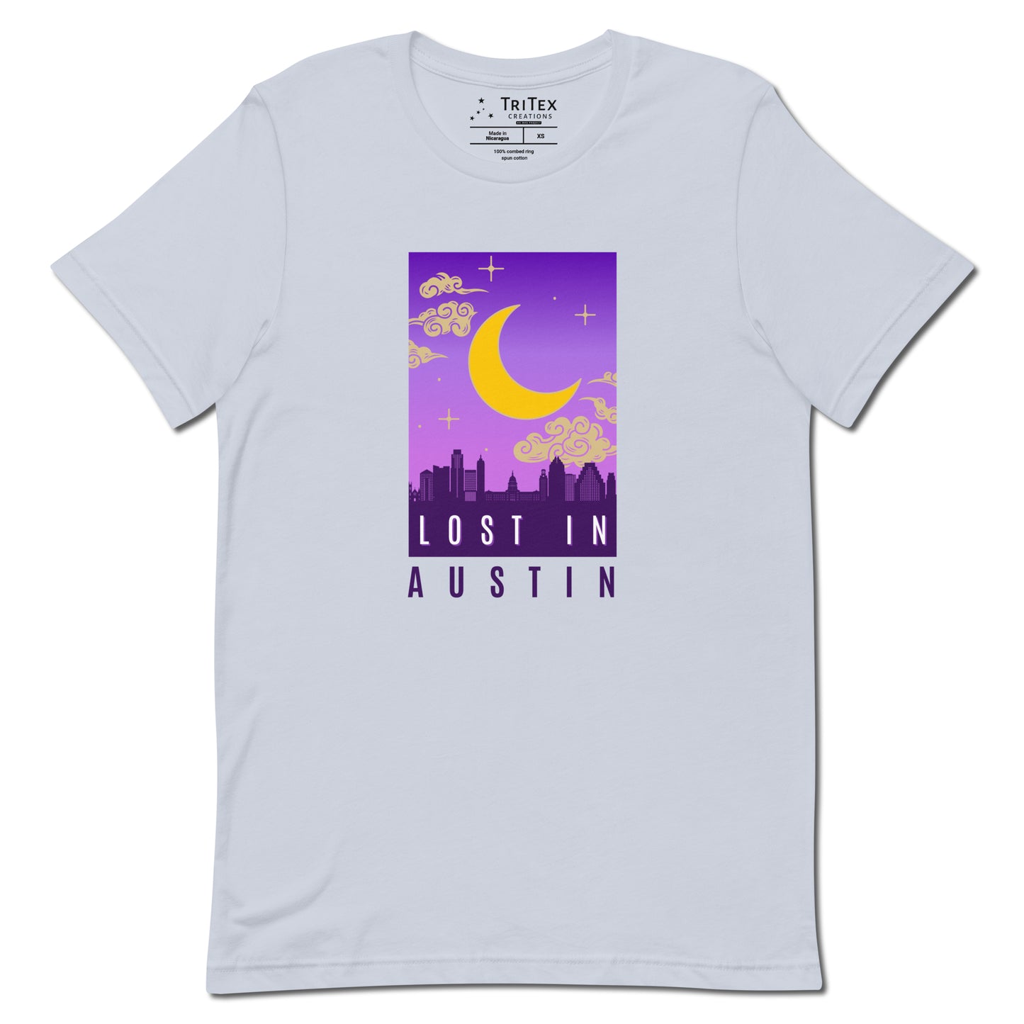 A light blue t-shirt featuring the moon over the Austin skyline with the words "Lost in Austin".