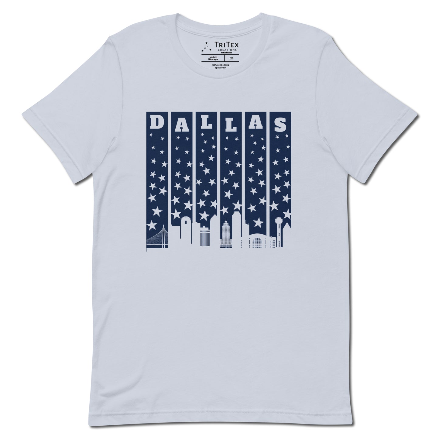 A light blue t-shirt with with the silhouette of the Dallas skyline underneath some stars and the name "Dallas".