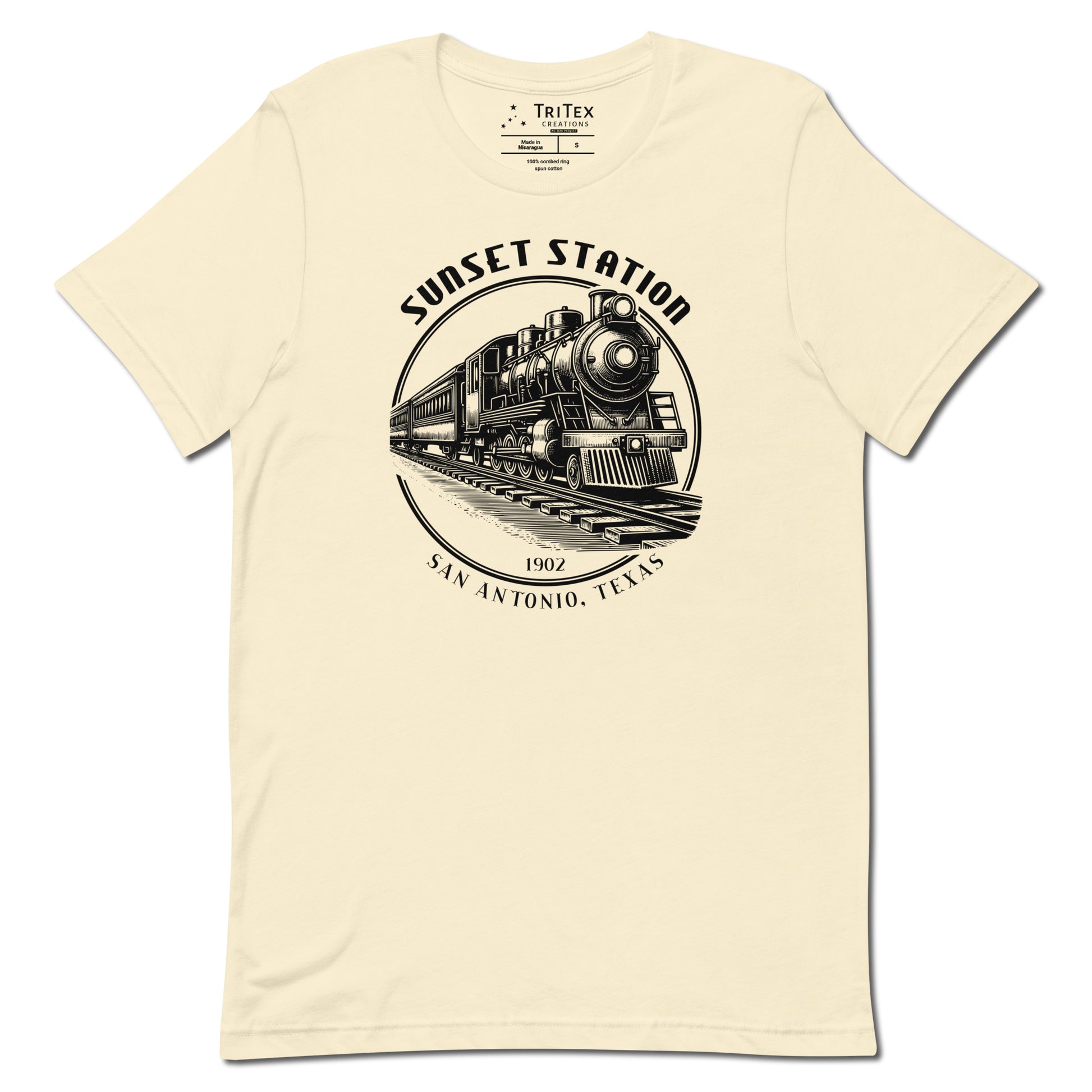 A natural-colored t-shirt featuring a vintage locomotive  with the words "Sunset Station. 1902. San Antonio, Texas".