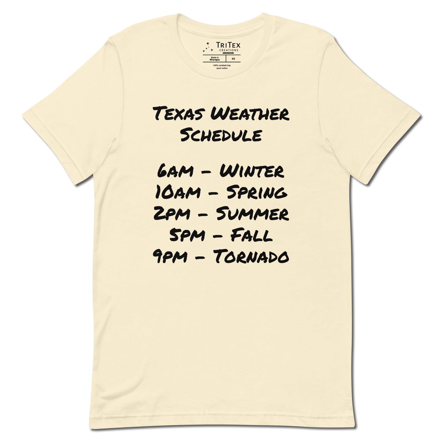 A natural-colored t-shirt with a handwritten list that reads "Texas Weather Schedule. 6AM - Winter. 10AM - Spring. 2PM - Summer. 5PM - Fall. 9PM - Tornado".