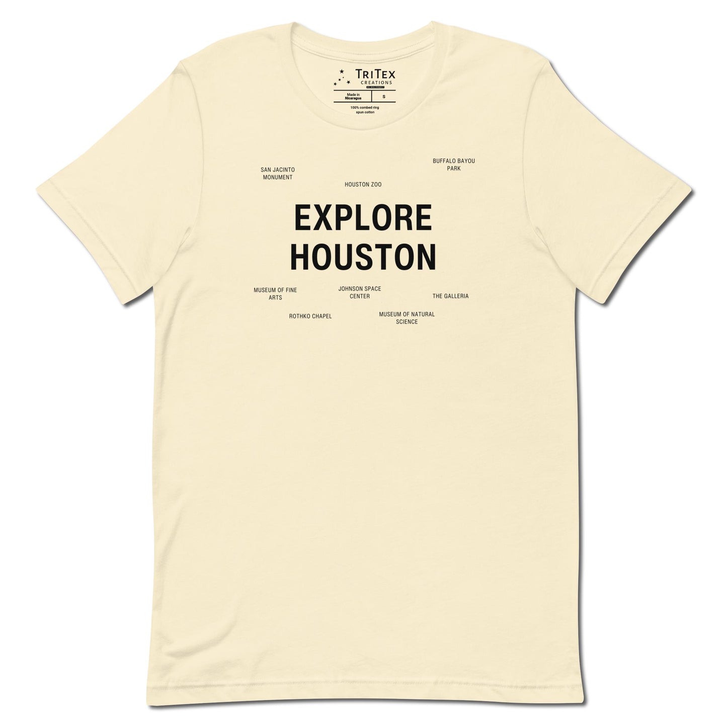 A natural-colored t-shirt which reads "Explore Houston" in big, bold text with smaller text elements naming Houston's landmarks.