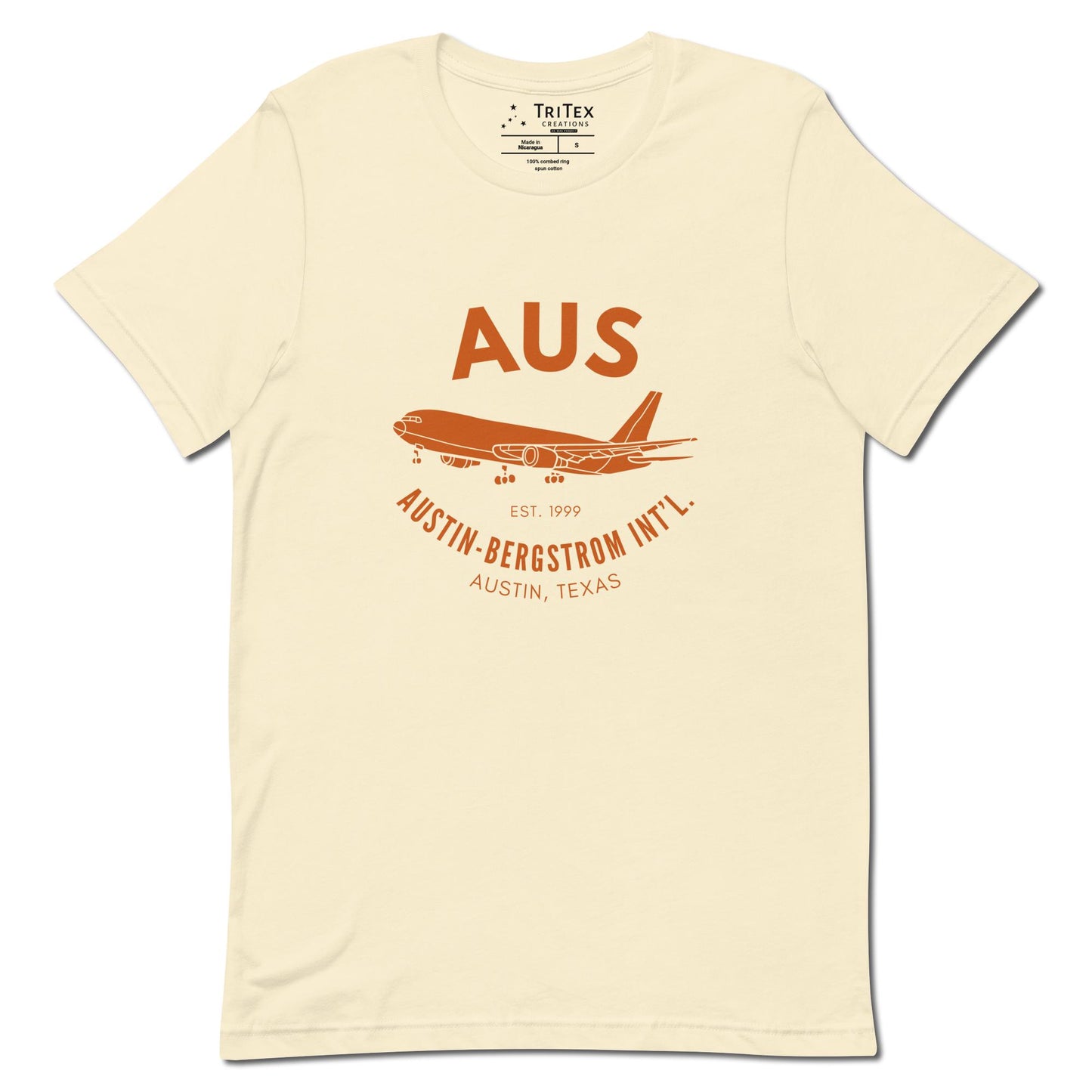 A natural-colored shirt featuring an image of an airplane with the words "AUS Est. 1999 Austin-Bergstrom Int'l. Austin, Texas".