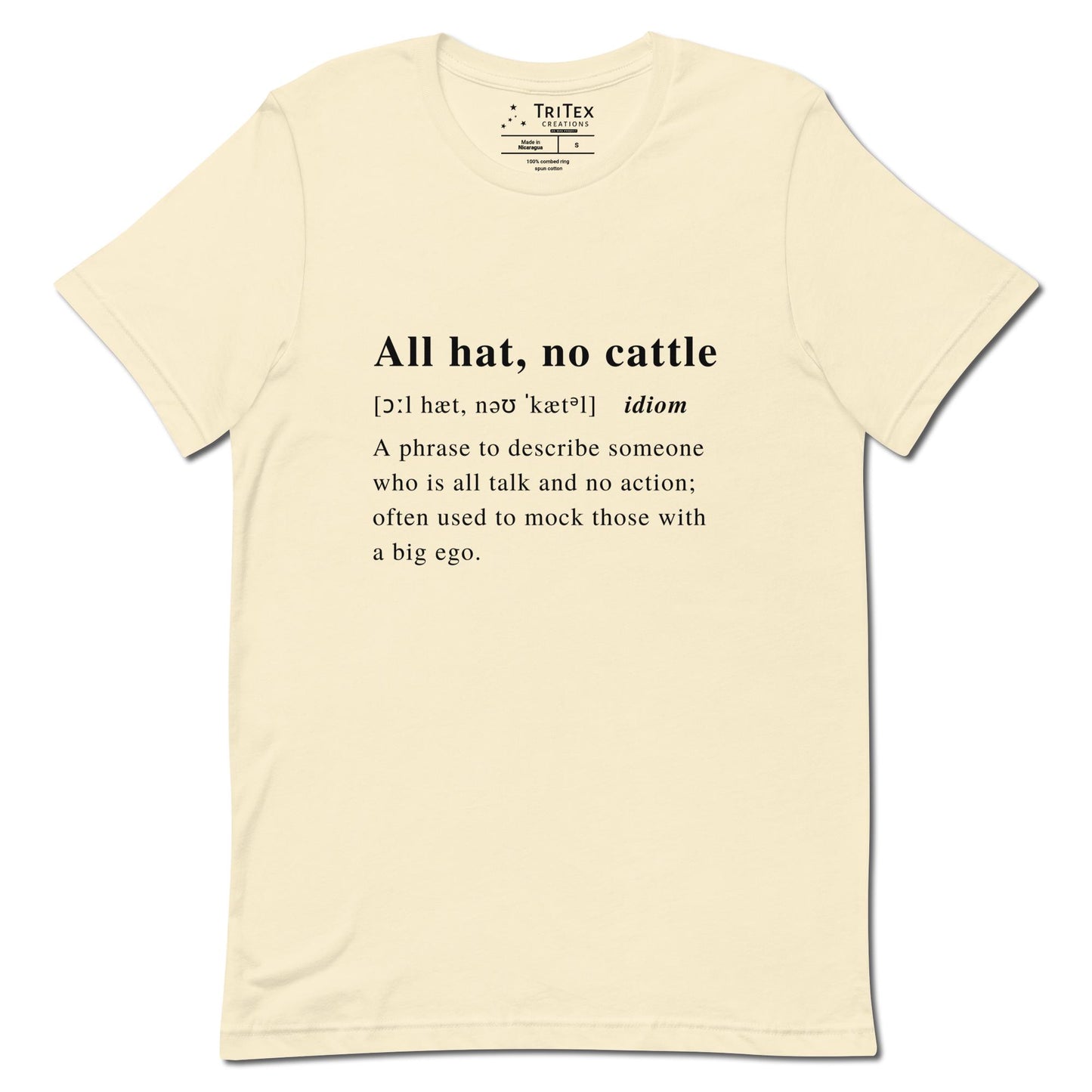 A natural-colored t-shirt with the definition of "All hat, no cattle" styled like a dictionary entry.