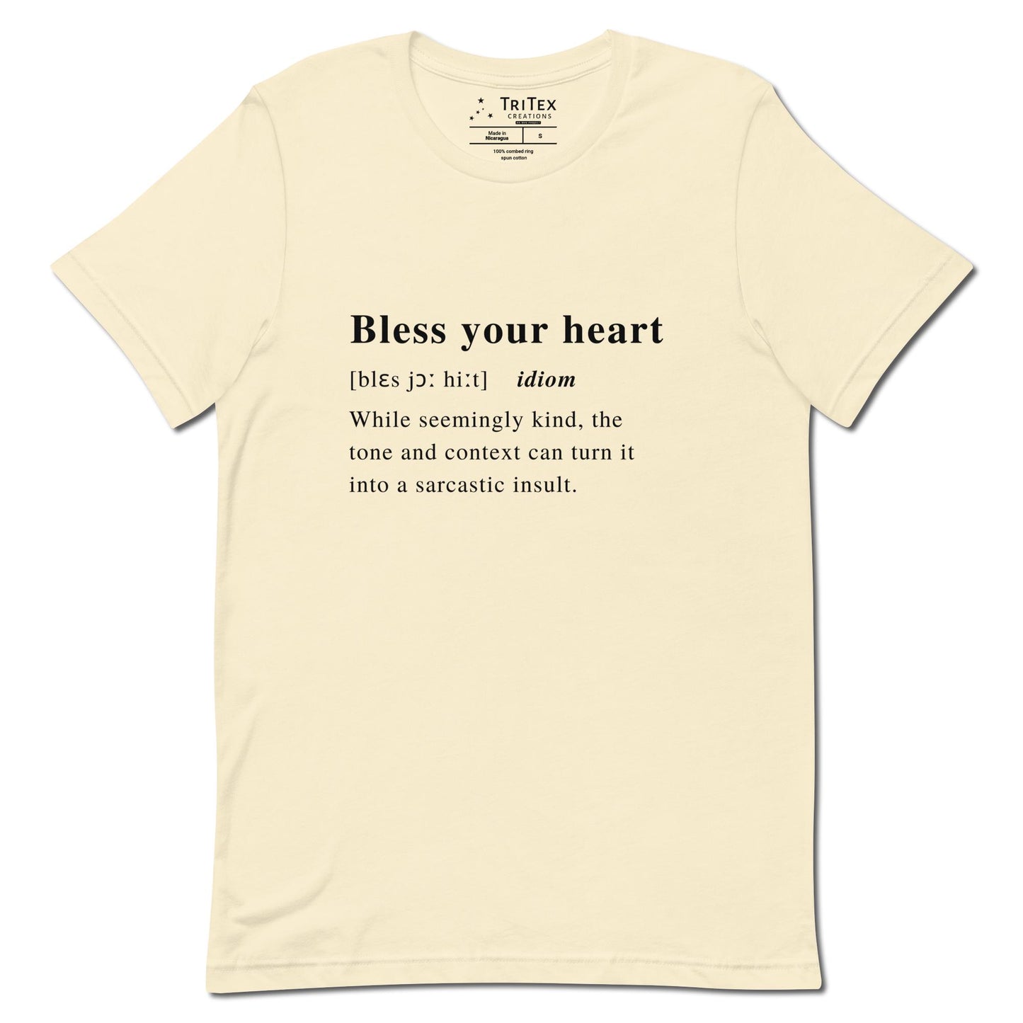 A natural-colored t-shirt with the definition of "Bless your heart" styled like a dictionary entry