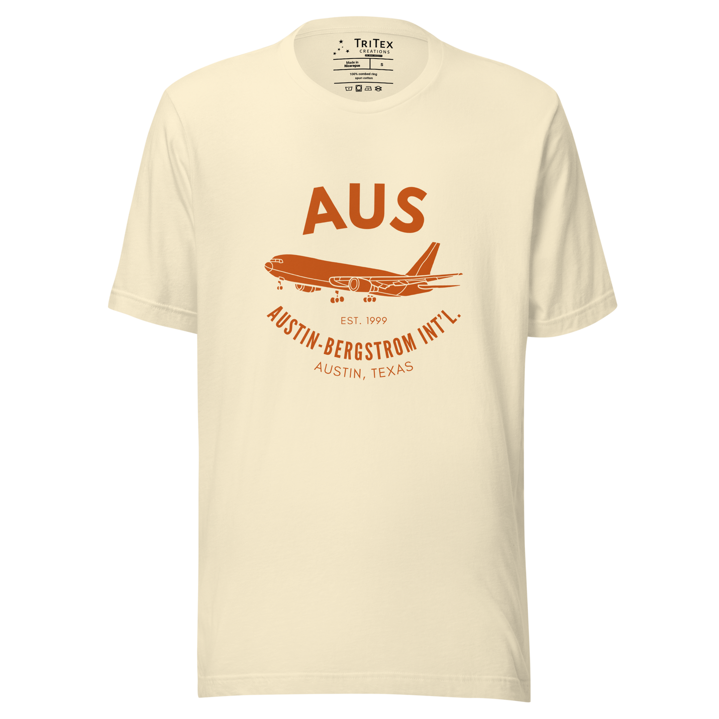 A natural-colored t-shirt with a silhouette of a passenger plane with the text "AUS Est. 1999 Austin-Bergstrom Int'l. Austin, Texas".