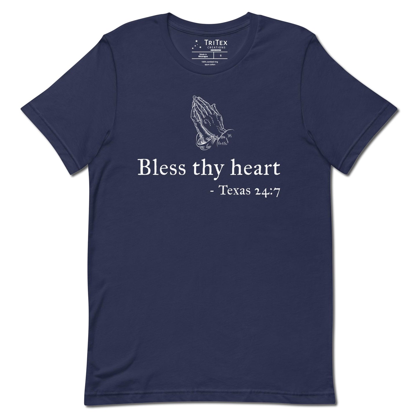 A navy t-shirt featuring a vintage illustration of hands clasped in prayer with the words "Bless thy heart - Texas 24:7"