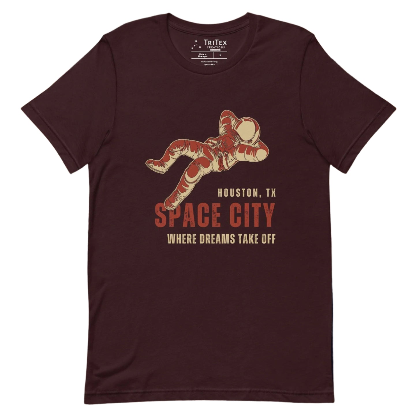 An oxblood black t-shirt featuring a dreaming astronaut with the words "Houston, TX. Space city. Where dreams come true".