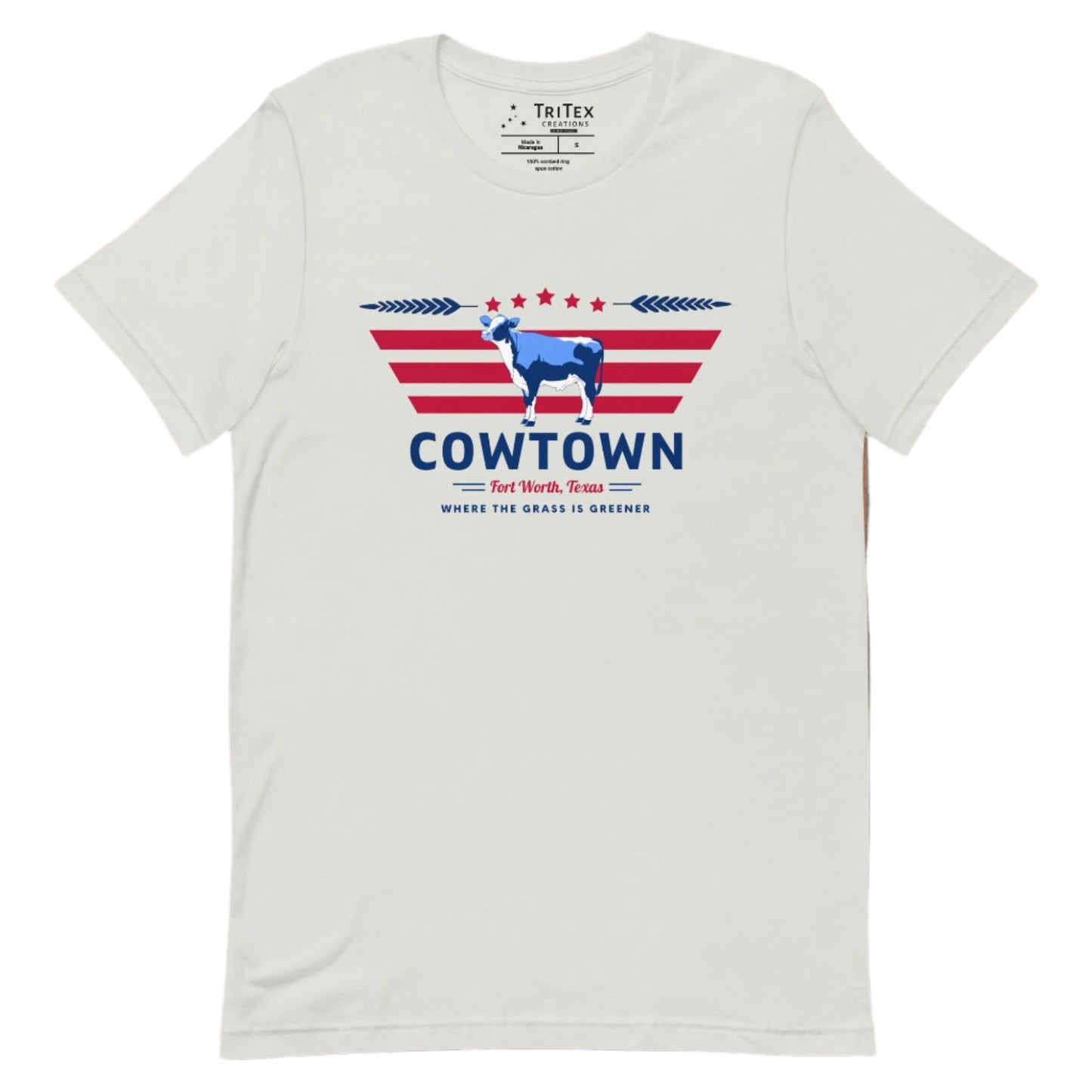 A silver t-shirt featuring a cow graphic and the text "Cowtown Fort Worth, Texas. Where the grass is greener".