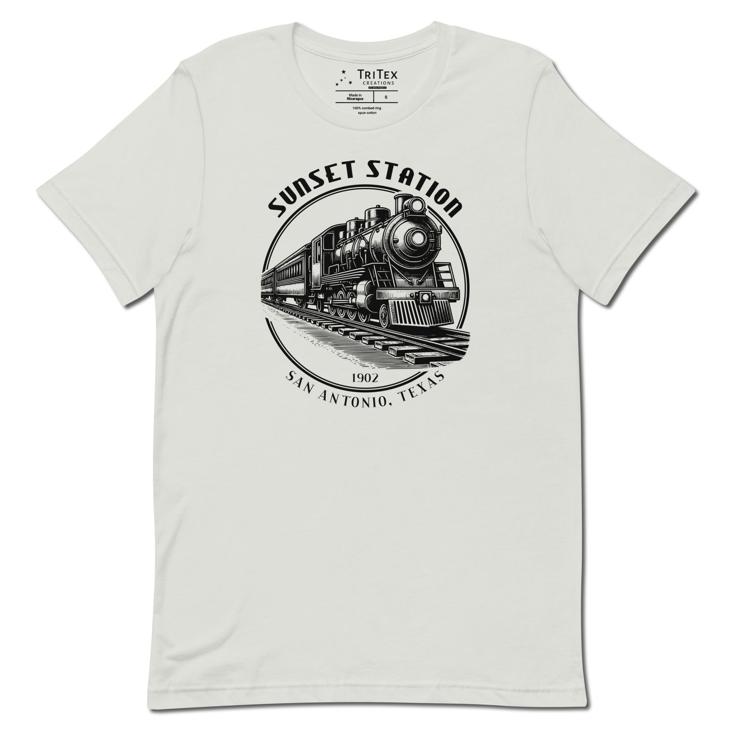 A silver t-shirt featuring a vintage locomotive  with the words "Sunset Station. 1902. San Antonio, Texas".