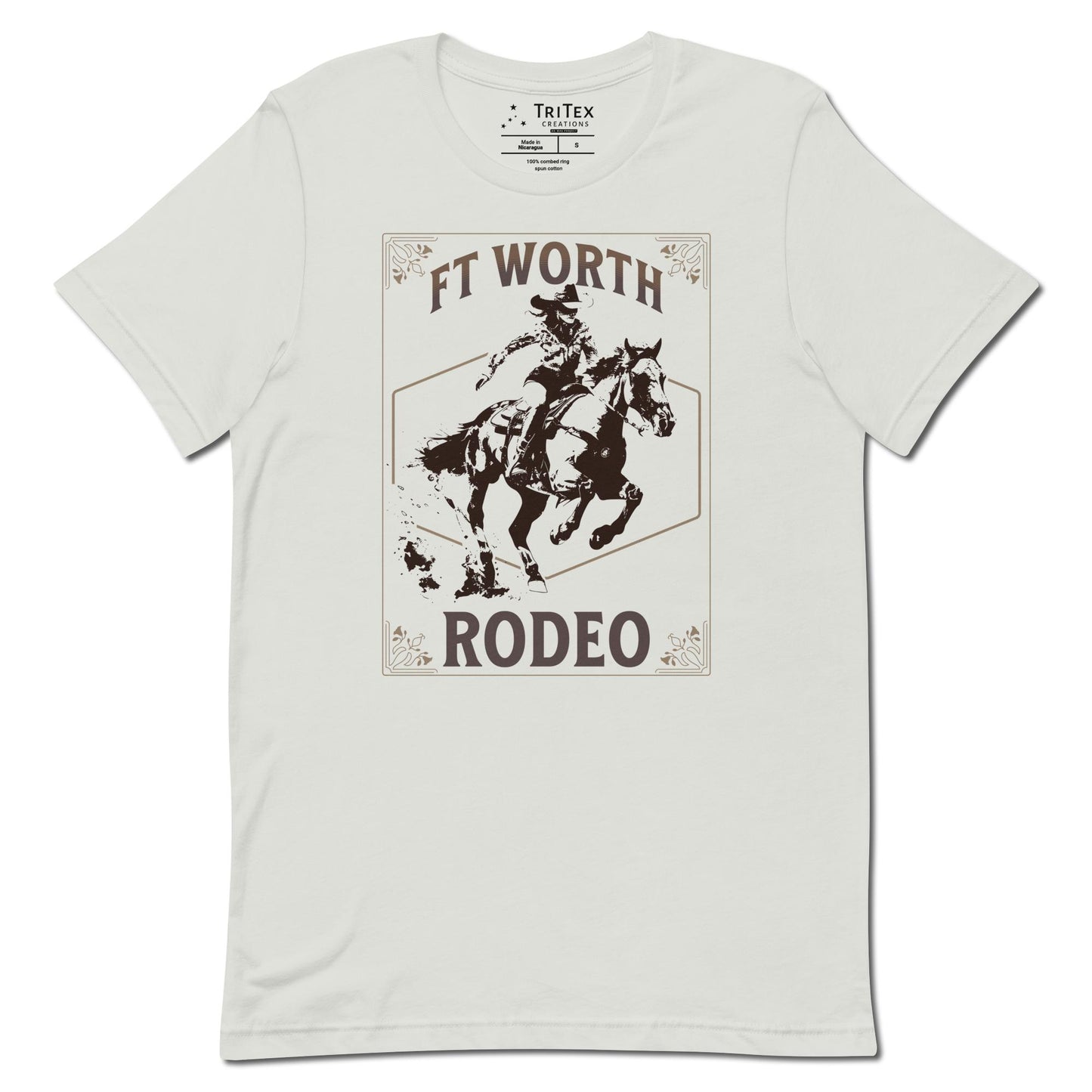 A silver t-shirt featuring a cowgirl on a horse with a decorative border and the words "Ft Worth Rodeo".