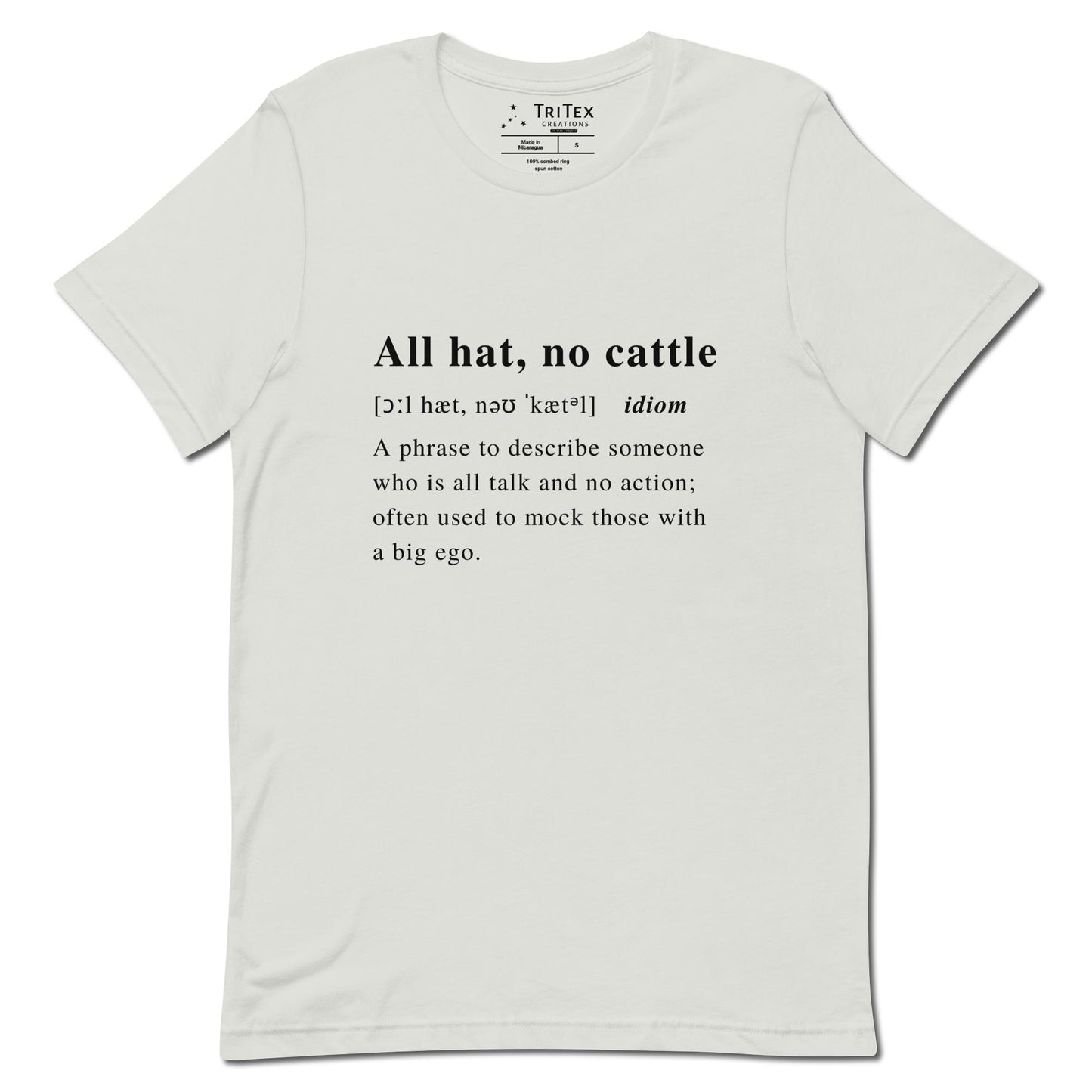 A silver t-shirt with the definition of "All hat, no cattle" styled like a dictionary entry.