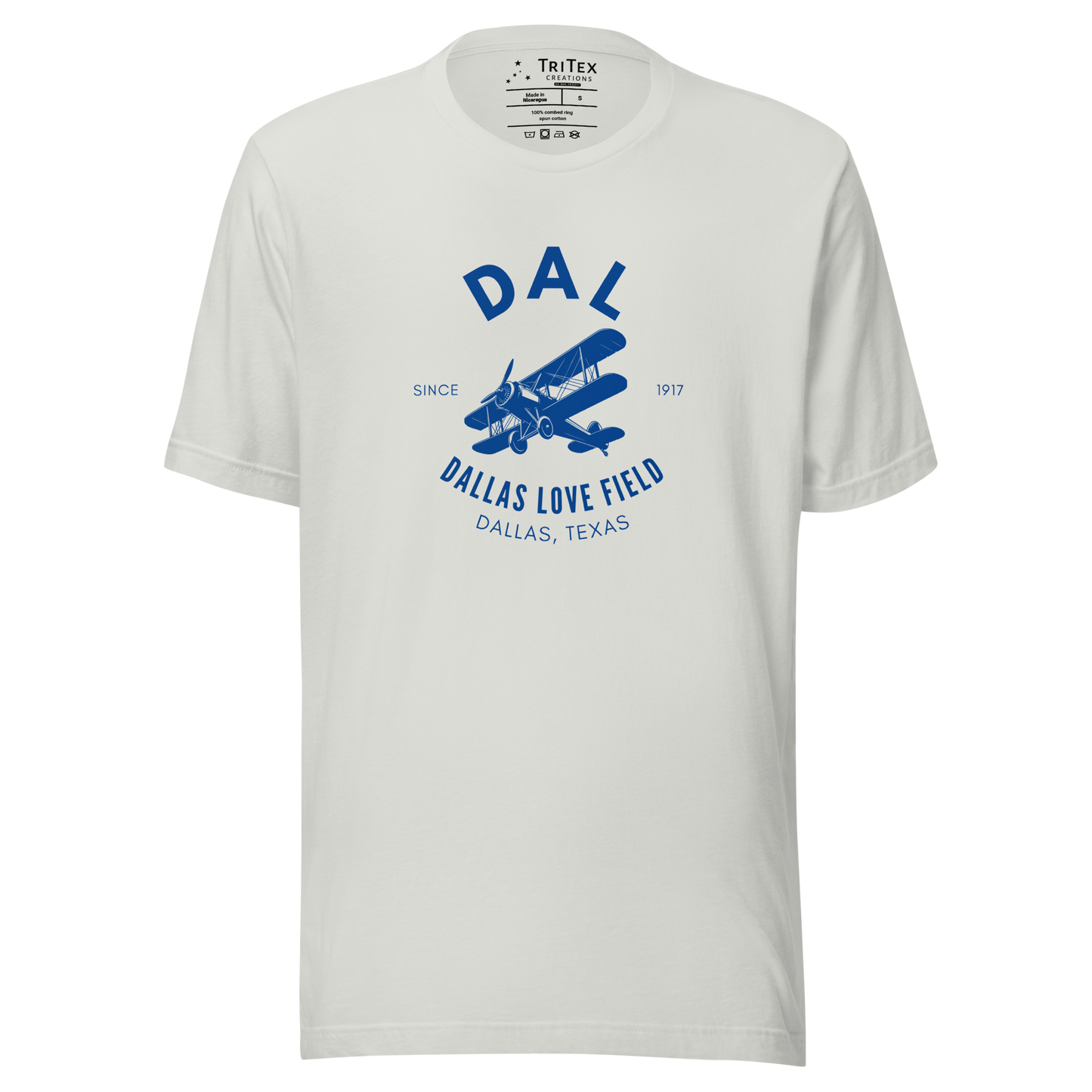 A silver t-shirt with a silhouette of a biplane with the text "DAL Since 1917 Dallas Love Field. Dallas, Texas".
