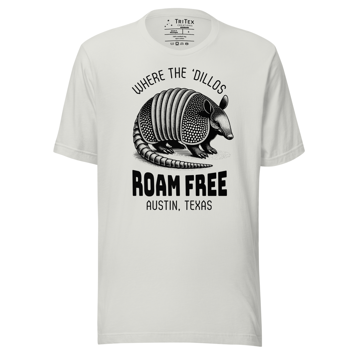 A silver t-shirt featuring a vintage illustration of an armadillo with the words "Where the 'dillos roam free. Austin, Texas".