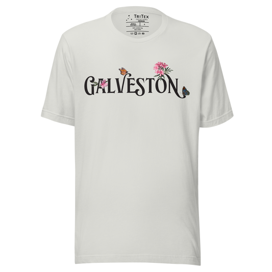 A silver t-shirt with the name of "Galveston" amongst oleanders and butterflies.