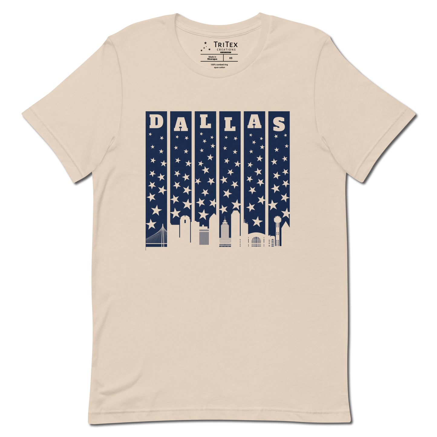 A soft cream t-shirt with with the silhouette of the Dallas skyline underneath some stars and the name "Dallas".