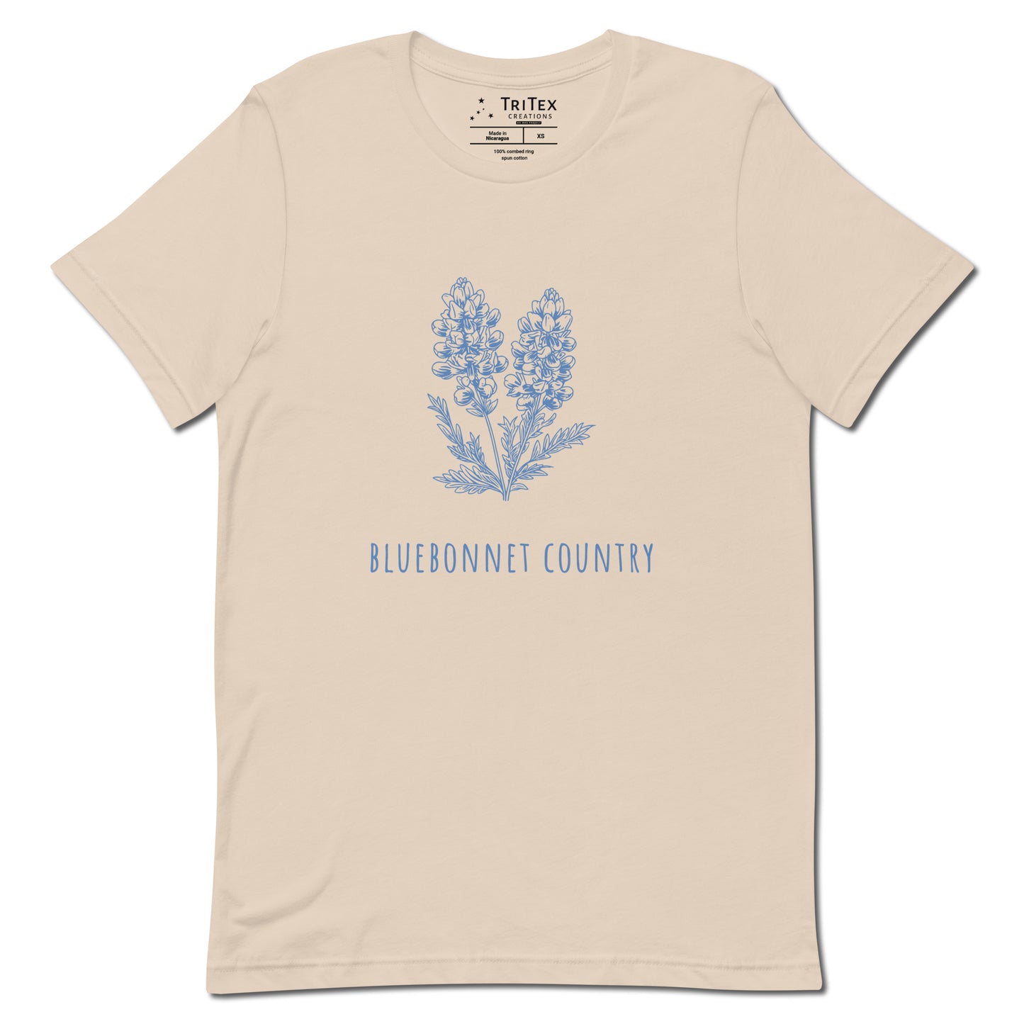 A soft cream t-shirt featuring an image of a bluebonnet flower with the words "Bluebonnet country" underneath.