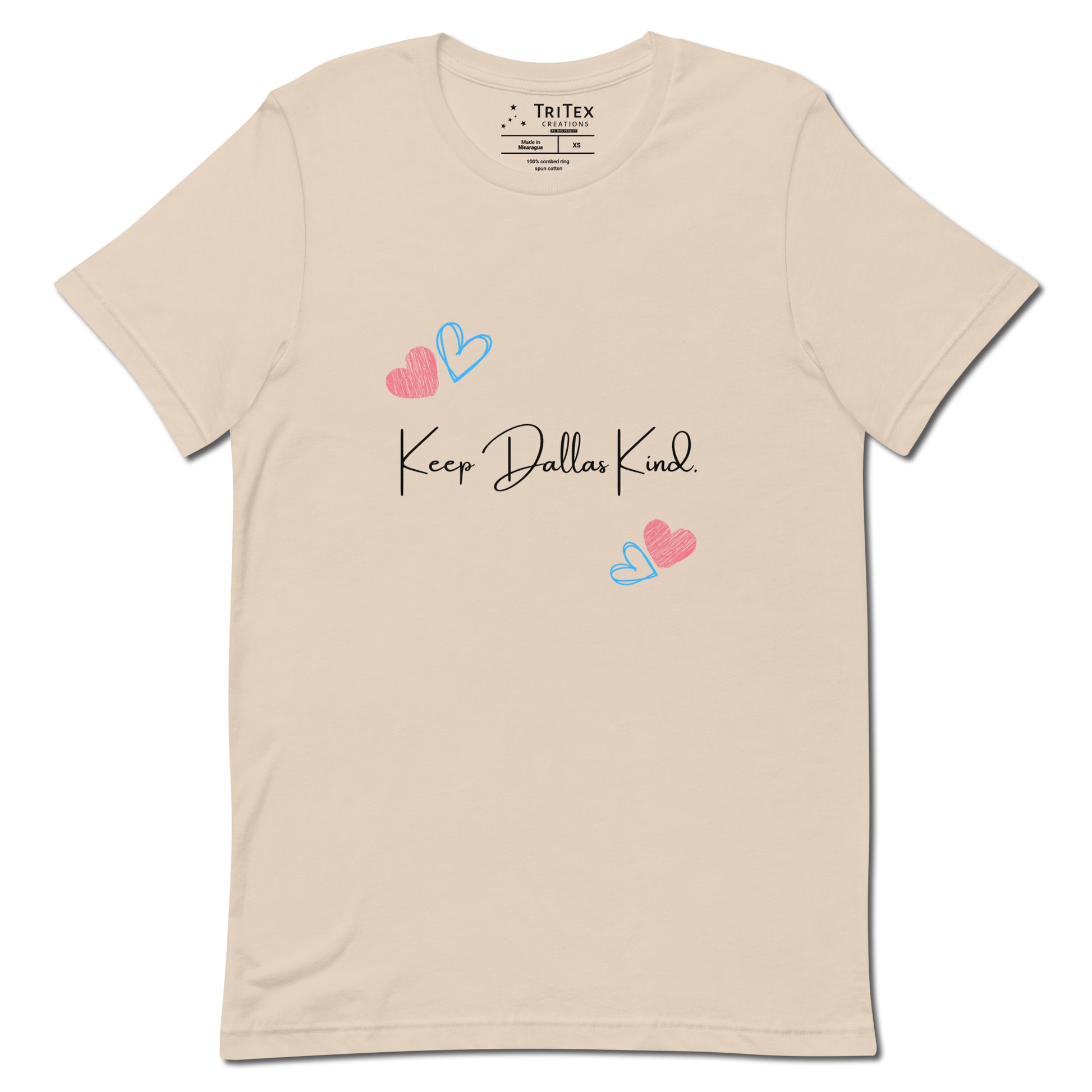 A soft cream t-shirt with hearts and the text "Keep Dallas Kind".