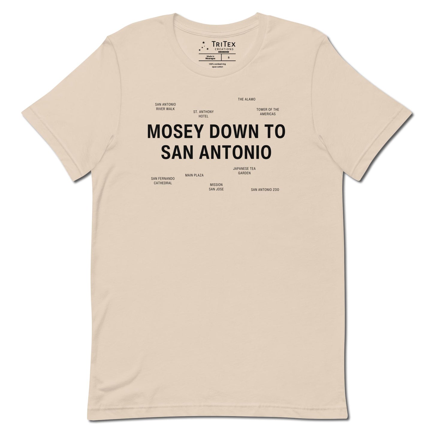 A soft cream t-shirt which reads "Mosey Down To San Antonio" in big, bold text with smaller text elements naming San Antonio's landmarks.