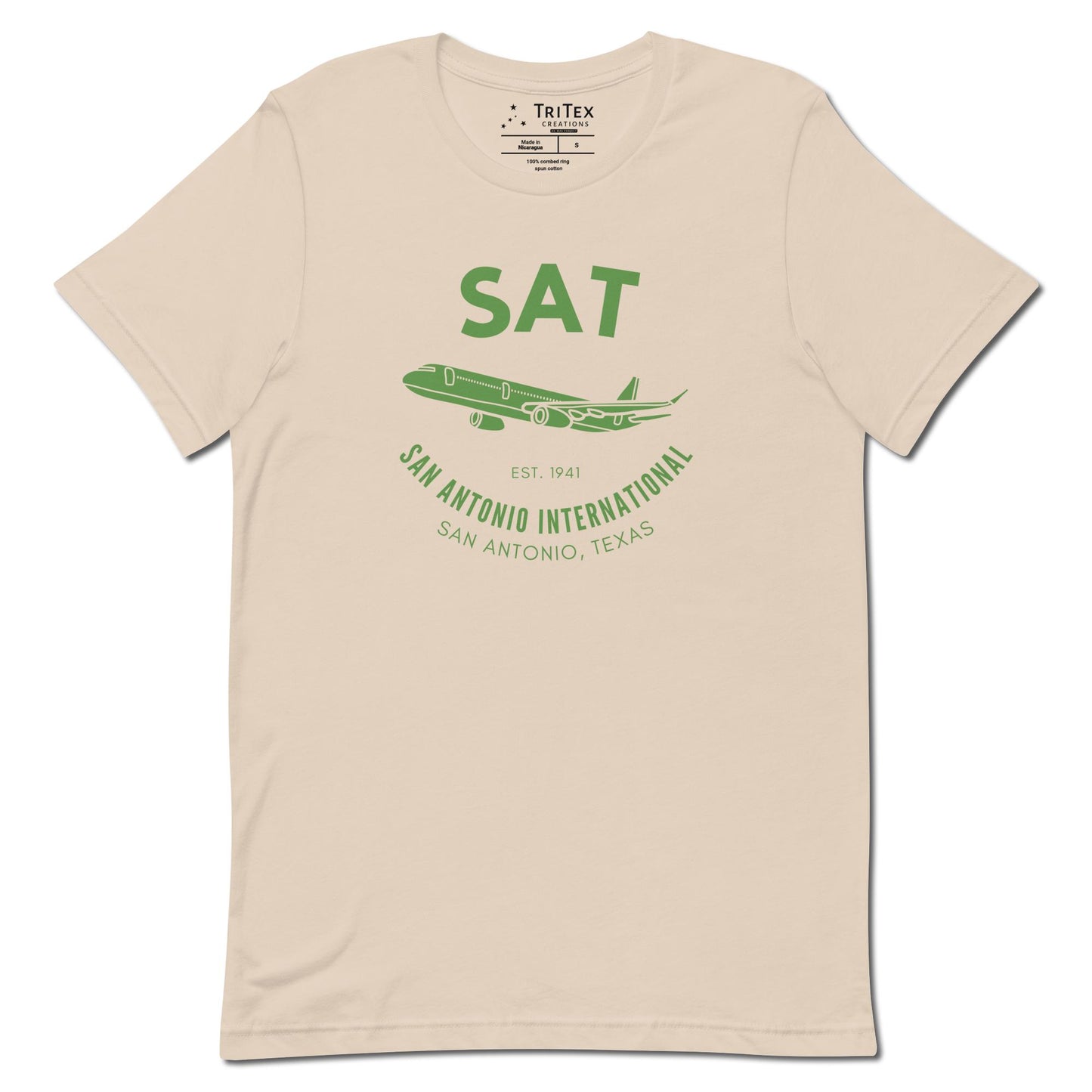 A soft cream t-shirt featuring a silhouette of a passenger plane with the text "SAT. Est. 1941. San Antonio International. San Antonio, Texas".