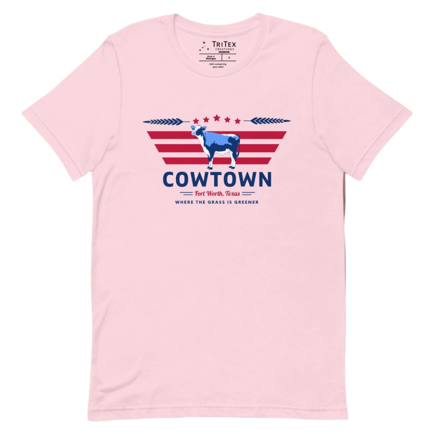 A soft pink t-shirt featuring a cow graphic and the text "Cowtown Fort Worth, Texas. Where the grass is greener".