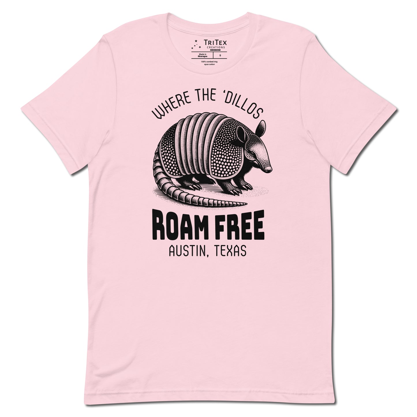 A soft pink t-shirt featuring a vintage illustration of an armadillo with the words "Where the 'dillos roam free. Austin, Texas".